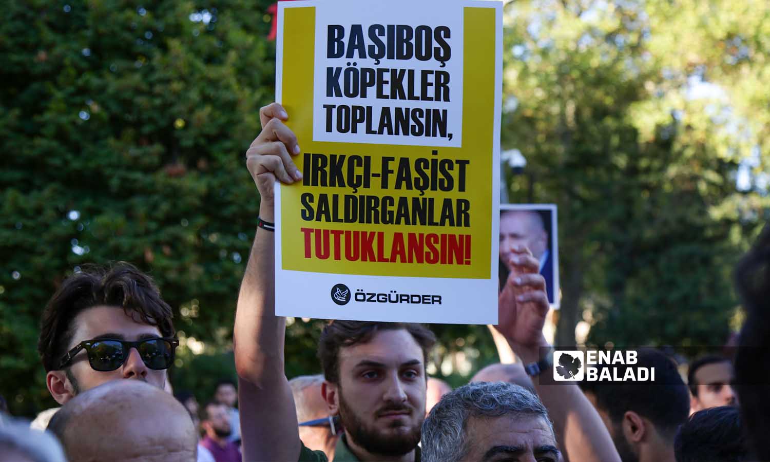 المتظاهرون يرفعون لافتات تطالب باعتقال"المهاجمين الفاشيين العنصريين" خلال وقفة تضامنية مع اللاجئين السوريين في تركيا- اسطنبول 16 من أيلول 2023 (- يوسف حمّص)